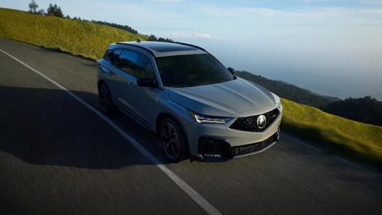 2026 Acura MDX Type S Advance Package in Urban Gray Pearl front driving on a coastal road (Premium Performance SUV).